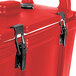 A red Cambro insulated soup carrier with black handles and latches.