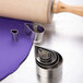 A rolling pin and Ateco stainless steel cookie cutters on a purple surface.
