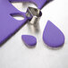A purple and silver Ateco teardrop cutter set on a counter.