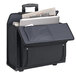 A black Solo classic rolling catalog case with a laptop and newspaper inside.