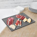 A Tablecraft granite cast aluminum rectangular cooling platter with meat and cheese on it.