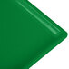 A close-up of a green Tablecraft cast aluminum rectangular cooling platter.