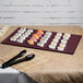 A Tablecraft maroon speckle rectangular metal cooling platter with sushi on a table.