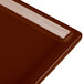 A close-up of a brown rectangular Tablecraft cooling platter.