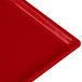 A close-up of a red Tablecraft cast aluminum rectangular cooling platter.