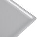 A natural cast aluminum rectangular cooling platter with a silver edge.