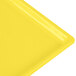 A close-up of a yellow Tablecraft rectangular cooling platter.