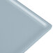A close-up of a gray Tablecraft rectangular cast aluminum cooling platter.