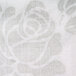 A close-up of a white paper with a silver floral pattern.