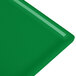A green cast aluminum rectangular cooling platter with a flat edge.