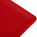 A close up of a red Tablecraft cast aluminum cooling platter.