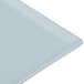 A close-up of a gray Tablecraft cast aluminum rectangular cooling platter.