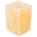 A Sterno alabaster square candle holder with a lit yellow candle inside.