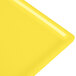 A close-up of a yellow rectangular Tablecraft cooling platter.
