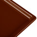 A brown cast aluminum rectangular cooling platter on a table.