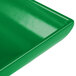 A close-up of a Tablecraft green cast aluminum rectangular platter with a flared edge.