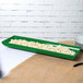A green rectangular Tablecraft tray with food in it.