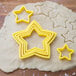 A white dough with star shaped cookie cutters.