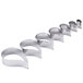 A row of stainless steel Ateco comma cookie cutters.