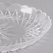 A clear plastic dish with a scalloped pattern.