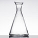 A clear glass Stolzle Pisa carafe with a clear liquid in it.