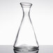A clear glass Stolzle Pisa carafe on a white background.