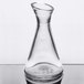 A clear glass carafe with a pointy top.