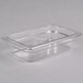 A clear plastic Cambro food pan on a counter.