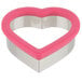 A Wilton metal heart-shaped cookie cutter with a pink handle.