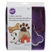 A package of Wilton metal cookie cutters including a dog, dog bone, and paw print cookie cutters.