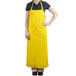A woman wearing a yellow Cordova dishwasher apron.