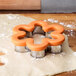 A Wilton flower-shaped cookie cutter with a comfort grip.
