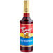A Torani Red Raspberry Flavoring Syrup 750 mL glass bottle with a red label.