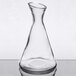 A clear glass beaker with a curved neck.