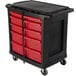 A black and red Rubbermaid TradeMaster mobile work center with red drawers.