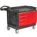 A black Rubbermaid TradeMaster tool cart with red drawers.