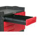 A black Rubbermaid TradeMaster cart with 4 drawers and a cabinet, including a black drawer with a red handle.