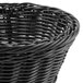 A black oval rattan basket with a handle.