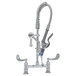 A chrome T&S deck mounted pre-rinse faucet with a hose and low flow spray valve.