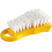 A yellow Thunder Group cutting board brush with white bristles.
