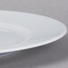 A Schonwald white porcelain plate with a wide rim.