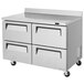 A Turbo Air stainless steel worktop freezer with four drawers on wheels.