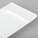 A white rectangular Schonwald porcelain platter with contoured edges on a gray surface.