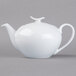 A close-up of a Schonwald white teapot with a lid and handle.