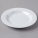 A Schonwald Donna white porcelain bowl with a wavy edge on a white surface.