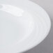A close up of a Schonwald white porcelain bowl with a curved edge.