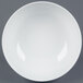 A bright white porcelain salad bowl with a white rim.