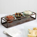 A Clipper Mill rectangular iron tray with three bowls of dip and chips.