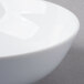 A close-up of a Schonwald round white porcelain bowl with a white rim.
