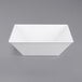 A white square bowl on a gray background.